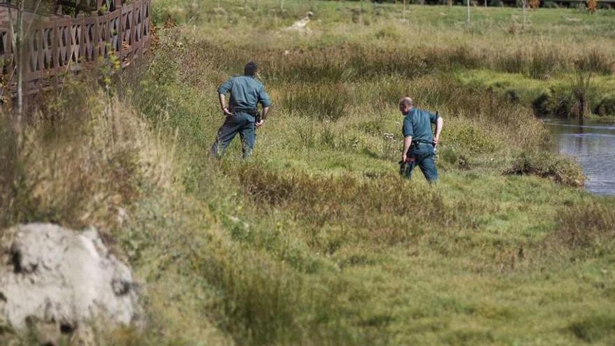 Dos agentes de la Guardia Civil rastrean una zona en busca de una pista sobre Diana Quer.