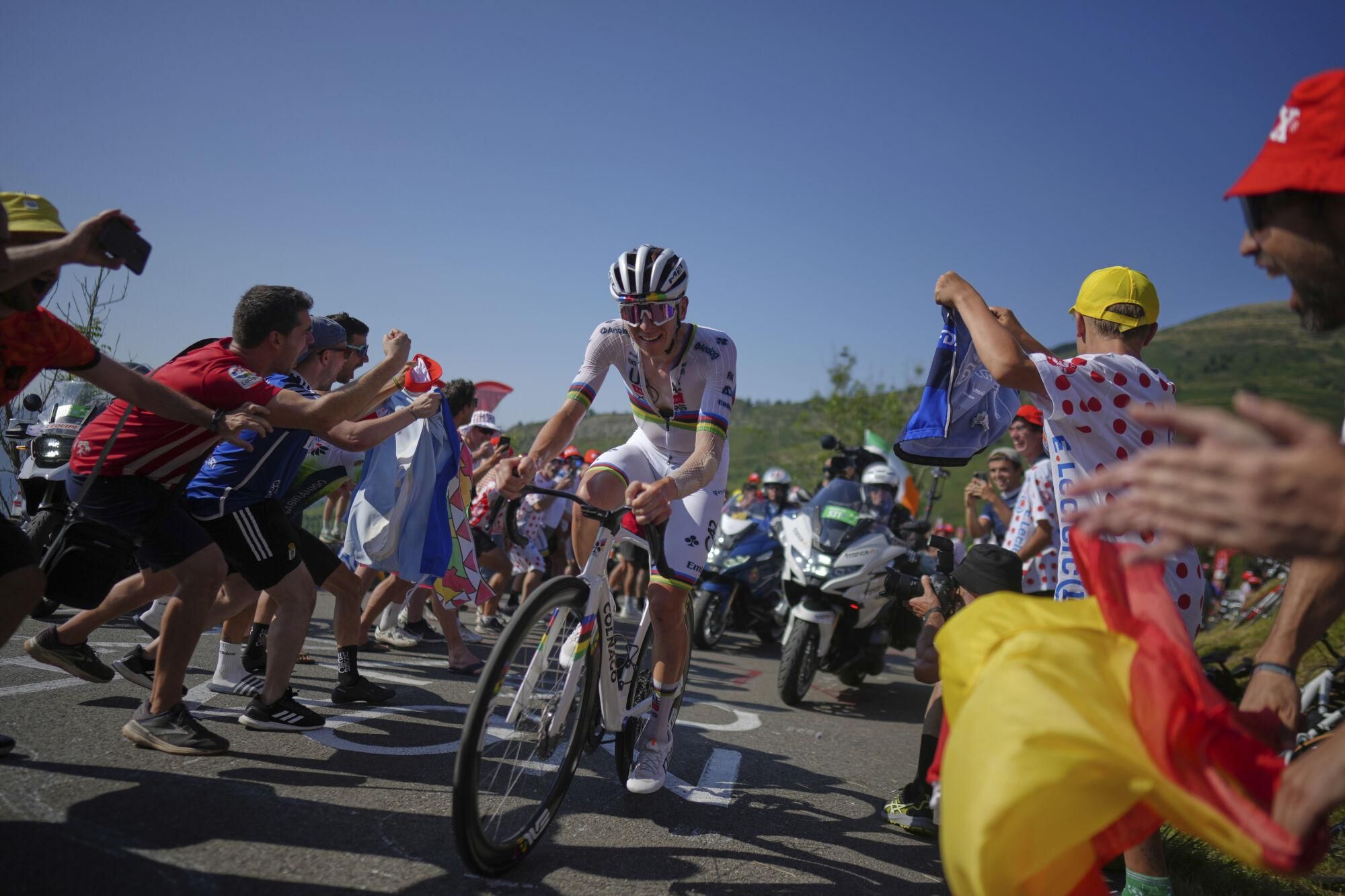 Slovenia's Tadej Pogacar climbs towards Hautacom to win the twelfth stage of the Tour de France cycling race over 180.6 kilometers (112.2 miles) with start in Auch and finish in Hautacam, France, Thursday, July 17, 2025. (AP Photo/Thibault Camus)