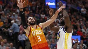 Dec 19, 2018; Salt Lake City, UT, USA; Utah Jazz guard Ricky Rubio (3) shoots against Golden State Warriors forward Draymond Green (23) in the fourth quarter at Vivint Smart Home Arena. Mandatory Credit: Jeff Swinger-USA TODAY Sports