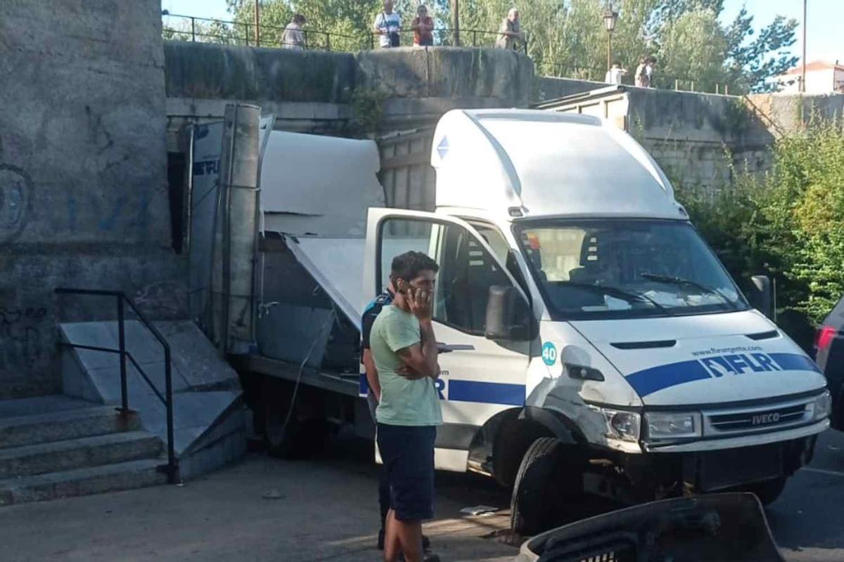 Un pequeño camión de reparto, tras quedar encajonado en uno de los arcos del puente de San Marcos, en León.
