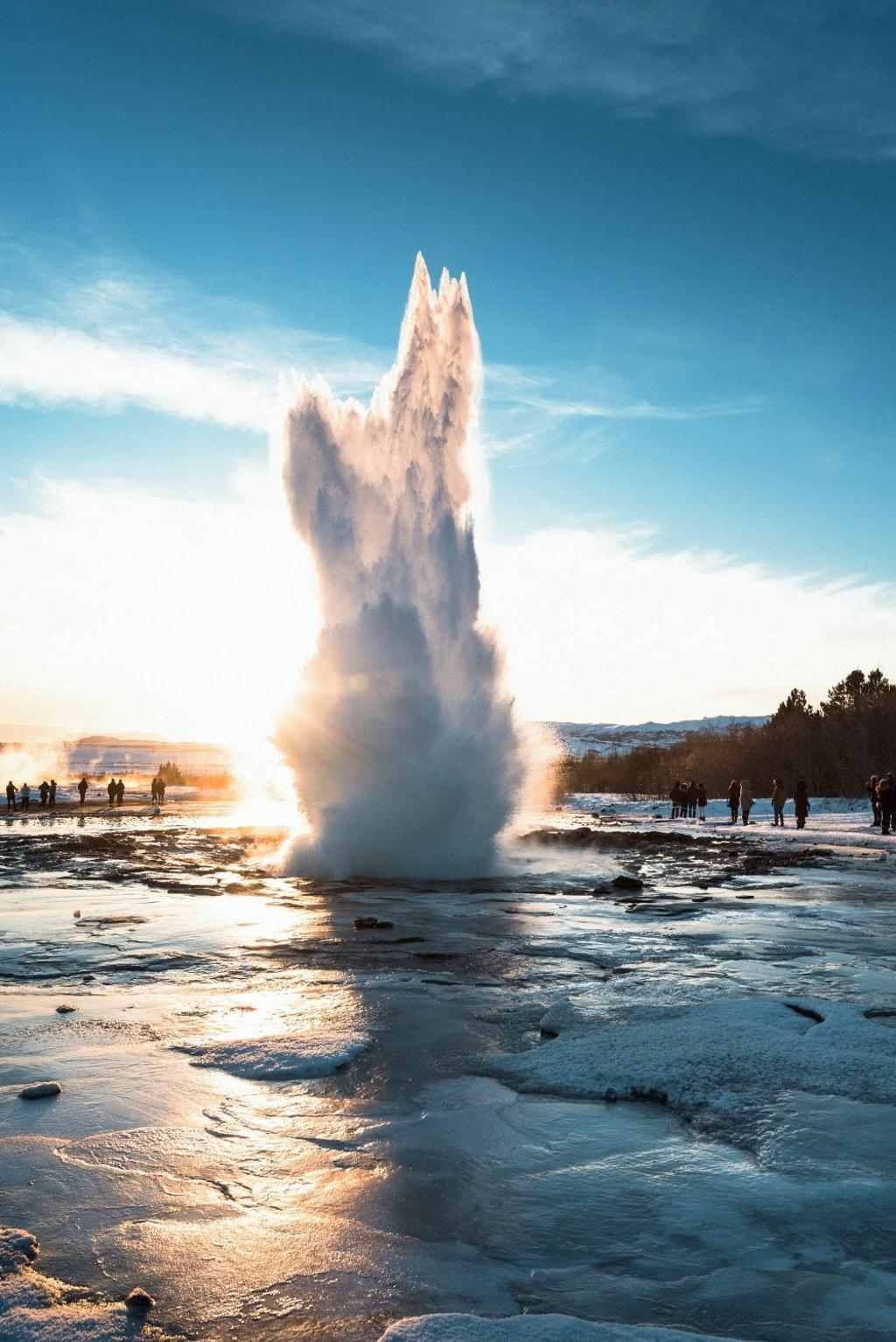 Uno de los géiseres de la isla y vista de Reikiavik