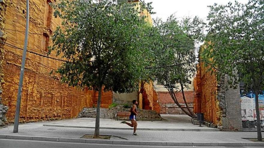 Dos bancs i una paperera en un solar recuperat a la Muralla