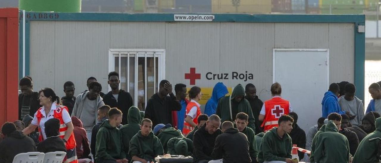 Migrantes aguardan tras llegar en patera al norte de Lanzarote.