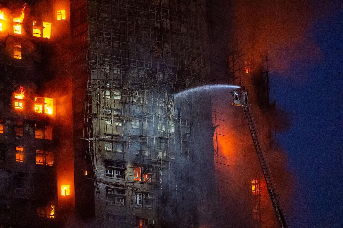 Firefighters try to extinguish a fire which broke out at Wang Fuk Court, a residential estate in the Tai Po district of Hong Kongs New Territories, Wednesday, Nov. 26 2025. (AP Photo/Chan Long Hei)