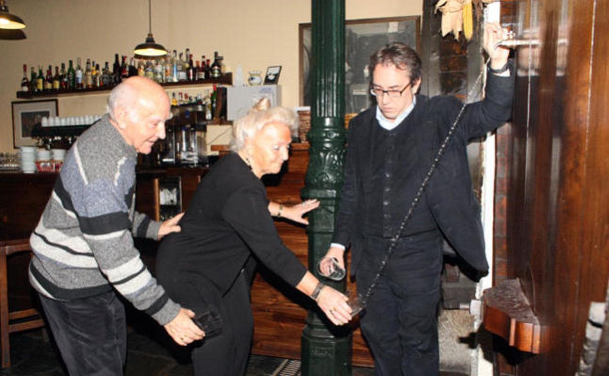 Koldo Mendizabal, de la sidrería vasca Zerain, en Madrid, escanciando al «txotx» sidra de Zapiain, ayer por la tarde, para Adelaida Aizpeolea y José Rodríguez, desde una «kupela» construida por un tonelero de Gijón. / módem press