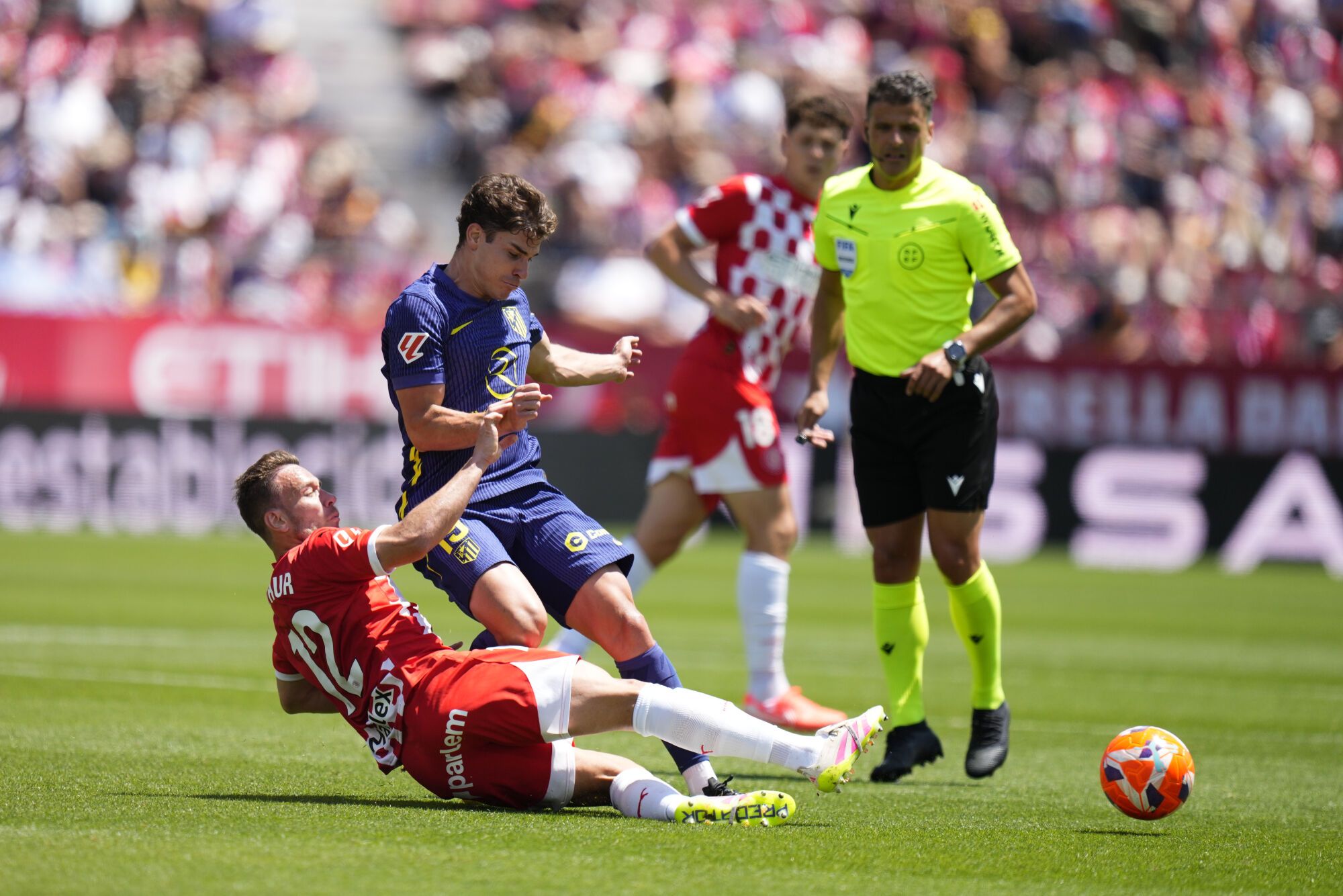 Midfielder Arthur Melo (L), of Girona, in action with forward Julian Alvarez (2L), of Atletico Madrid, during their LaLiga EA Sports league game at Moltilivi Stadium, in Girona, Catalonia, northeastern Spain, 25 May 2025. EFE/ Siu Wu