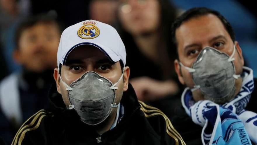 Seguidores madridistas, anoche, con mascarillas en el encuentro entre el Real Madrid y el Manchester City.