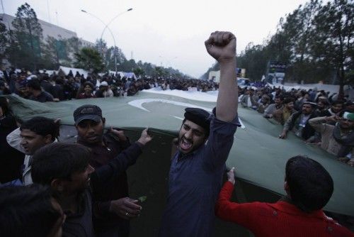 A supporter of Sufi cleric and leader of Minhaj-ul-Quran organisation Qadri chants slogan during the third day of protests in Islamabad