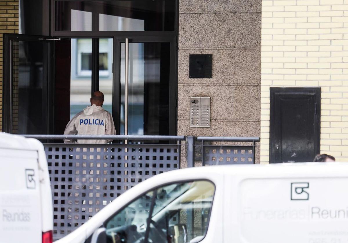 Un policía, accediendo al interior del bloque de viviendas de la calle Ámsterdam en el que fue asesinada Tatiana  Coinac el pasado mes de marzo. | Irma Collín