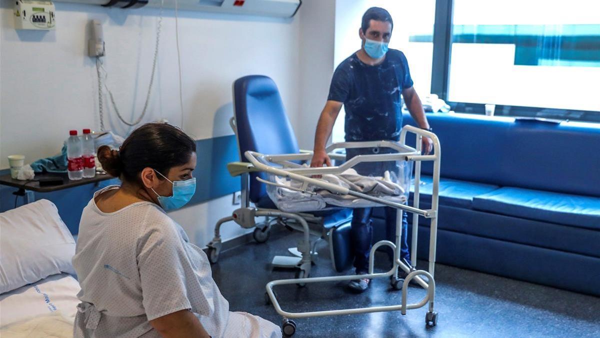 Una mujer  positivo en covid y su pareja, junto a su bebé recién nacido, en el Hospital Puerta de Hierro en Majadahonda, el pasado abril.