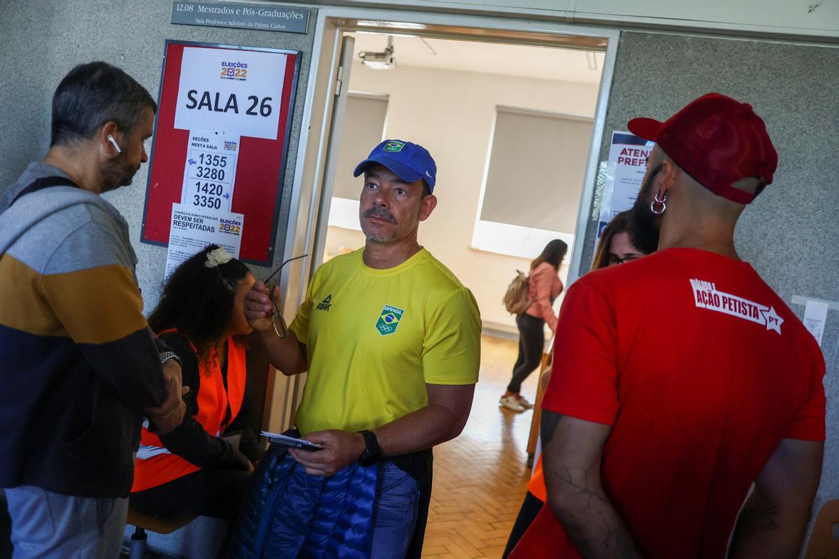 Citizens of Brazil wait in line to cast their vote for their countrys election, in Lisbon