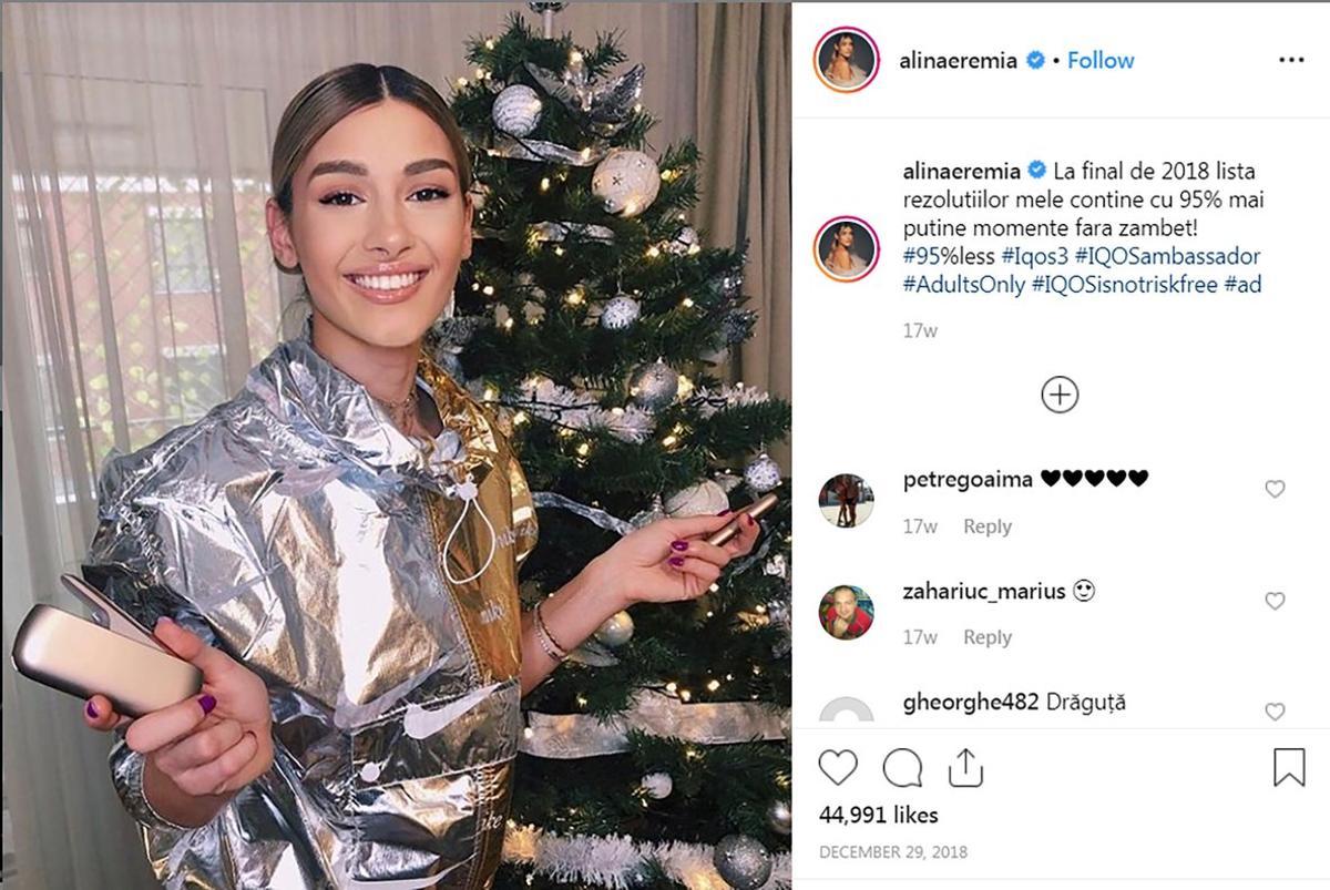 Alina Eremia, a Romanian actress and singer whose biography gives her age as 25, holds a gold-colored IQOS device in front of a Christmas tree as part of a campaign by Philip Morris International to market the device in an Instagram post December 29, 2018.  Alina Eremia/Social Media via REUTERS.  ATTENTION EDITORS - THIS IMAGE WAS PROVIDED BY A THIRD PARTY. NO ARCHIVES. NO RESALES. FOR USE ONLY WITH STORY PHILIPMORRIS-ECIG/INSTAGRAM