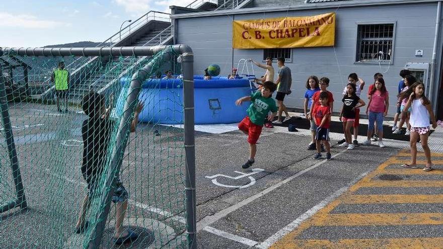 Unos niños disfrutan del campus de balonmano del CB Chapela, ayer, en el exterior del pabellón. // FdV