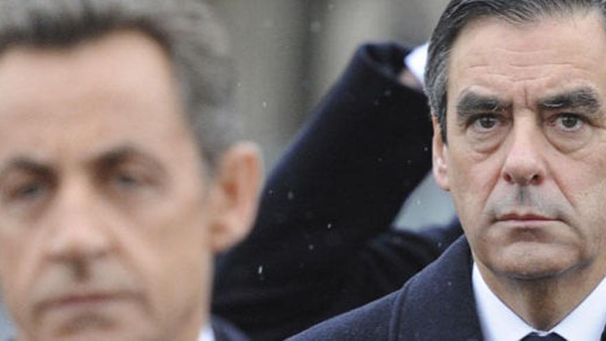 Sarkozy, en primer plano, y detrás de él Fillon.