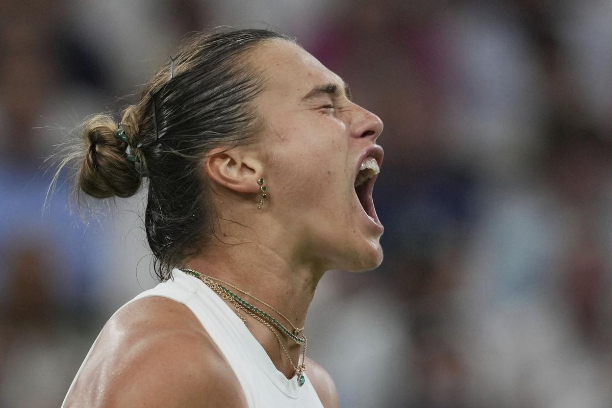 Aryna Sabalenka of Belarus reacts after winning a point against Emma Raducanu of Britain during a third round women's singles match at the Wimbledon Tennis Championships in London, Friday, July 4, 2025. (AP Photo/Kin Cheung)