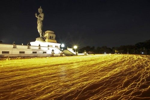 Monjes budistas alrededor de la estatua de Buda