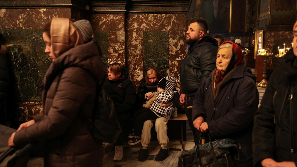 People attend early morning Ukrainian Orthodox Church services at St Volodymyr's Cathedral in Kyiv