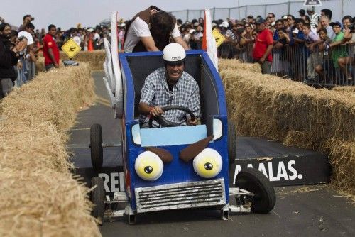 A competitor rides a home-made vehicle without an engine on a downhill track during the Red Bull Soapbox Race in Lima's Green Coast
