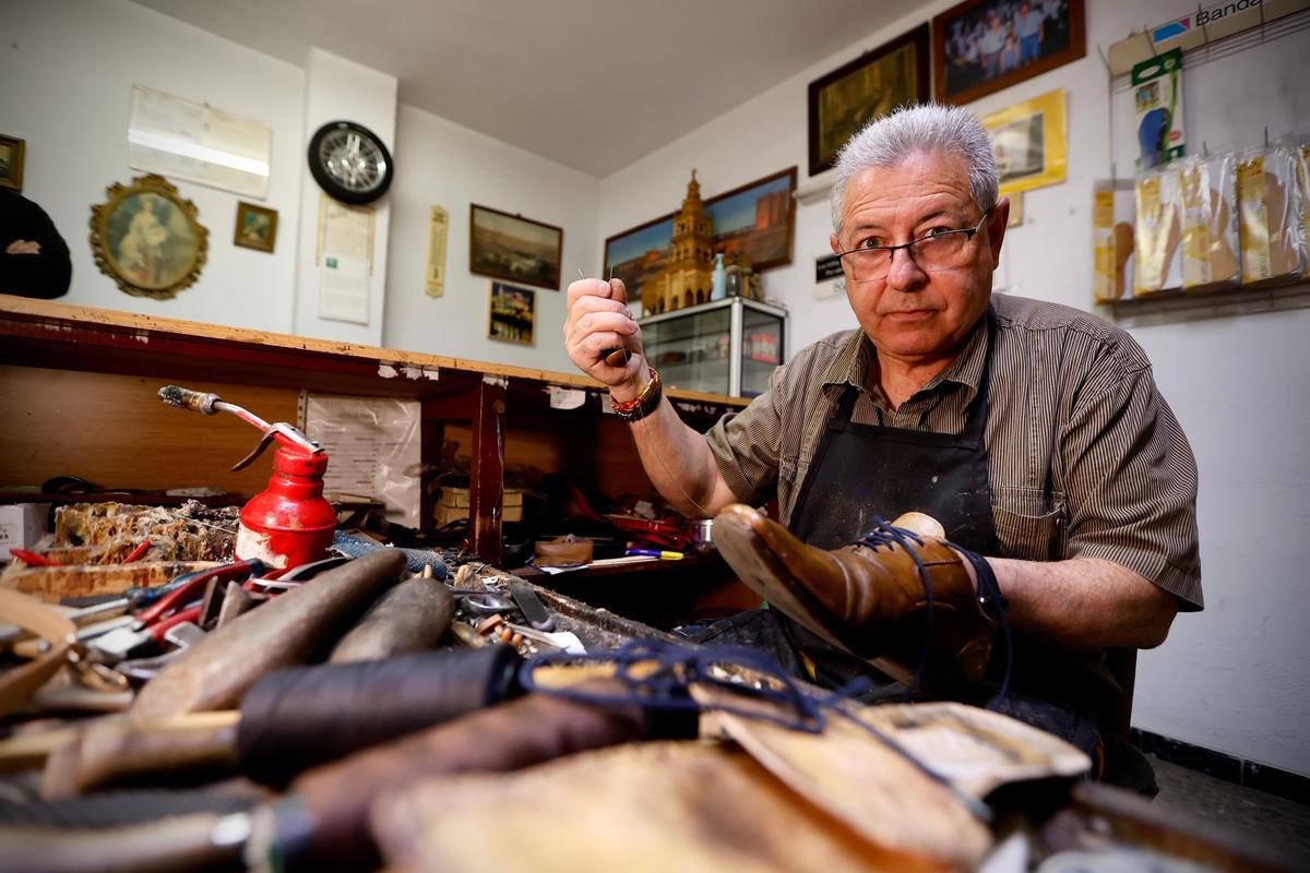 Francisco Clavero da una puntada a un zapato.