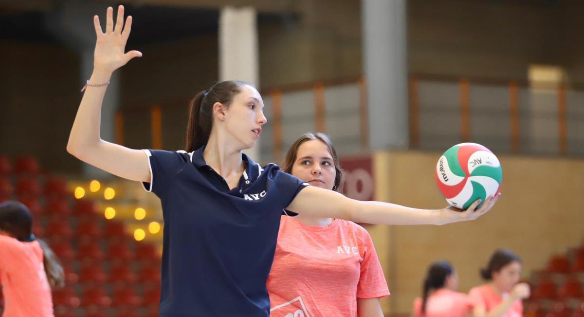 Raquel Montoro enseña a rematar a una de las jugadoras participantes en el campus de voleibol.
