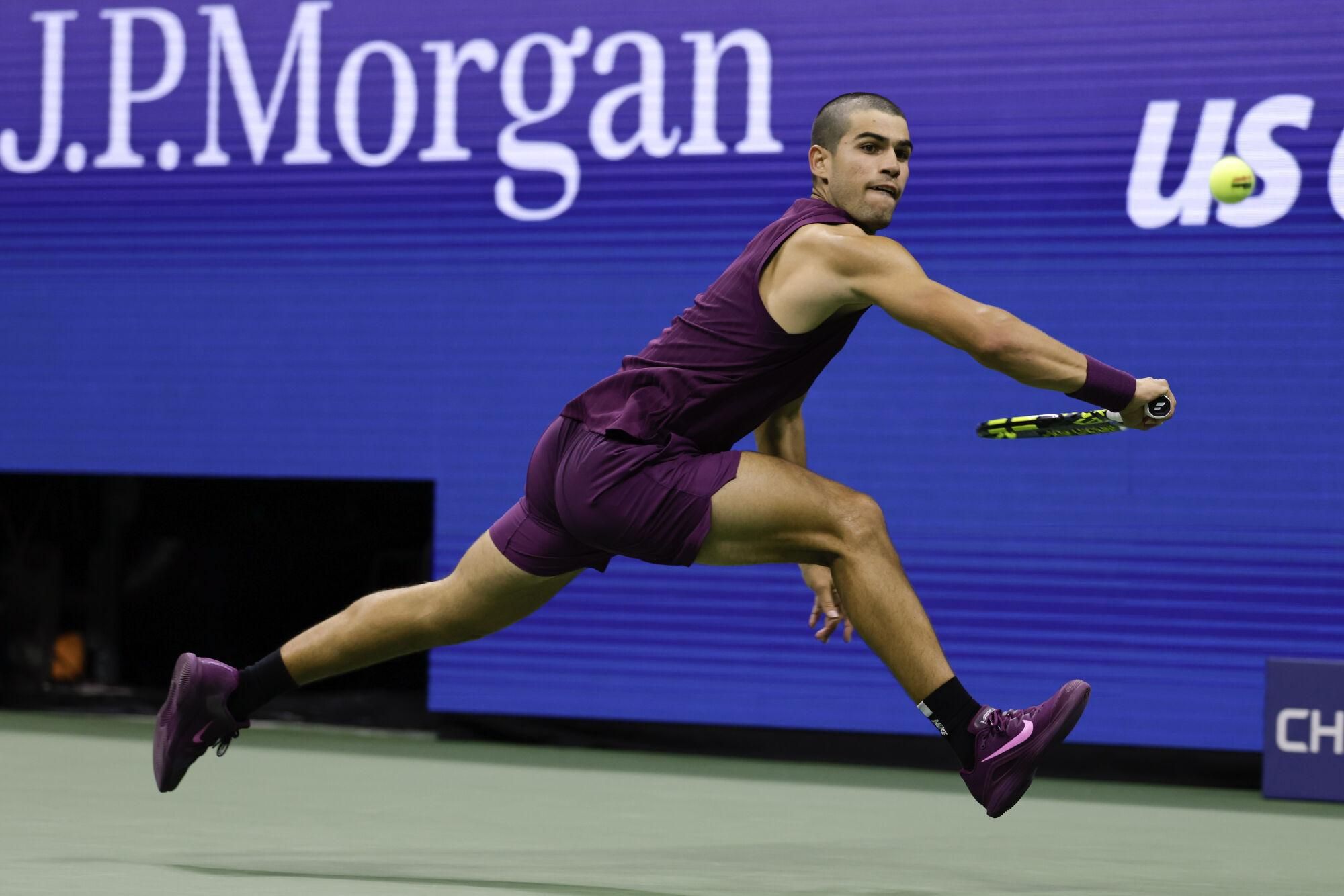 Carlos Alcaraz, of Spain, returns a shot to Mattia Bellucci, of Italy, during the second round of the U.S. Open tennis championships, Wednesday, Aug. 27, 2025, in New York. (AP Photo/Adam Hunger)