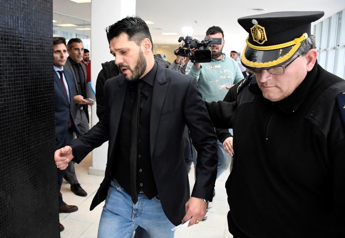 Matias Messi is escorted by a police officer outside the Criminal Justice Center in Rosario, Argentina, August 16, 2018. REUTERS/Stringer Matias Messi is escorted by a police officer outside the Criminal Justice Center in Rosario, Argentina, August 16, 2018. REUTERS/Stringer