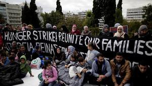 Refugees seeking reunification with family members in Germany sit in front of a banner announcing a hunger strike during a protest near the parliament building in Athens  Greece  November 1  2017  REUTERS Alkis Konstantinidis