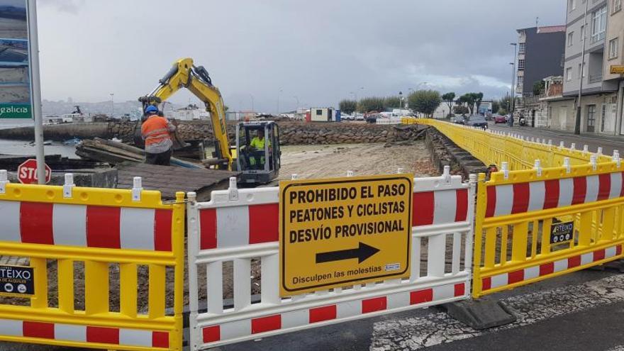 Toda la madera retirada y apilada, con la excavadora en la arena. | GONZALO NÚÑEZ