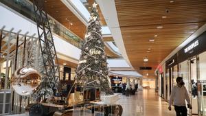 Un hombre camina junto a las decoraciones navideñas dentro de un centro comercial que ha reabierto cuando se alivian las restricciones de la enfermedad por coronavirus en Beirut (Líbano).