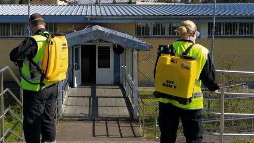 Dos soldados de la UME desinfectan uno de los accesos a la cárcel de Asturias.