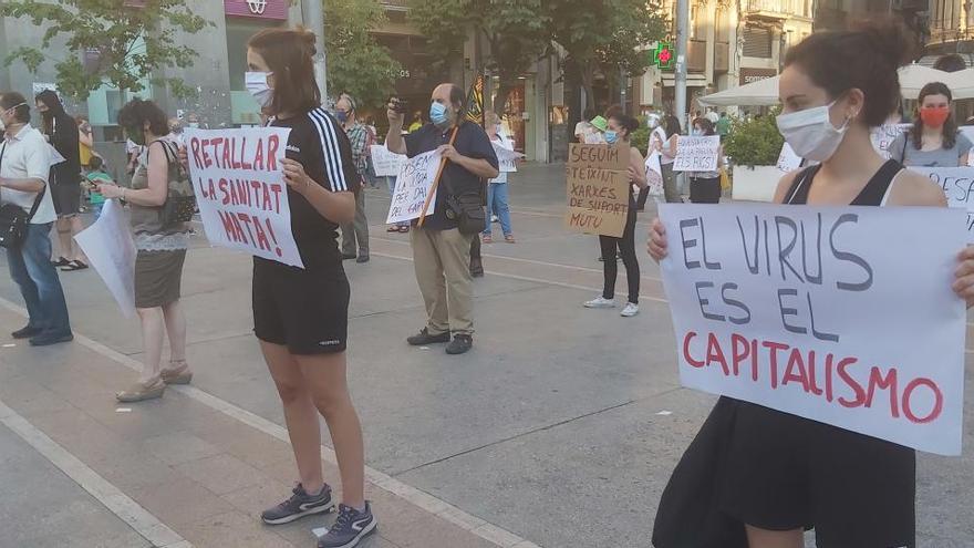 Els manifestants duien cartells amb lemes com: «El virus es el capitalismo»