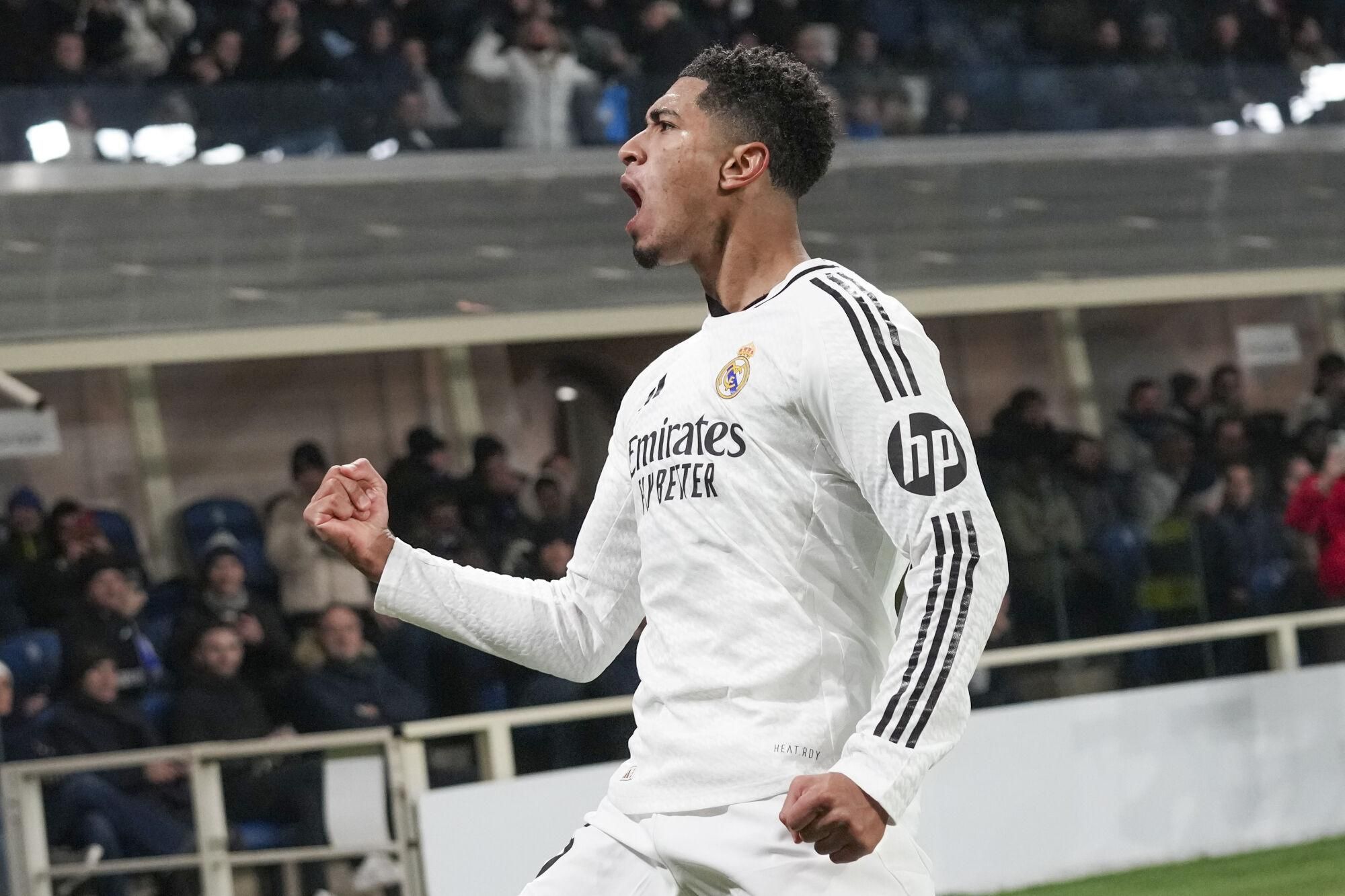 Real Madrid's Jude Bellingham celebrates after he scored his side's third goal during the Champions League opening phase soccer match between Atalanta and Real Madrid at the Bergamo's stadium, in Bergamo, Italy, Tuesday, Dec. 10, 2024. (AP Photo/Antonio Calanni). EDITORIAL USE ONLY / ONLY ITALY AND SPAIN