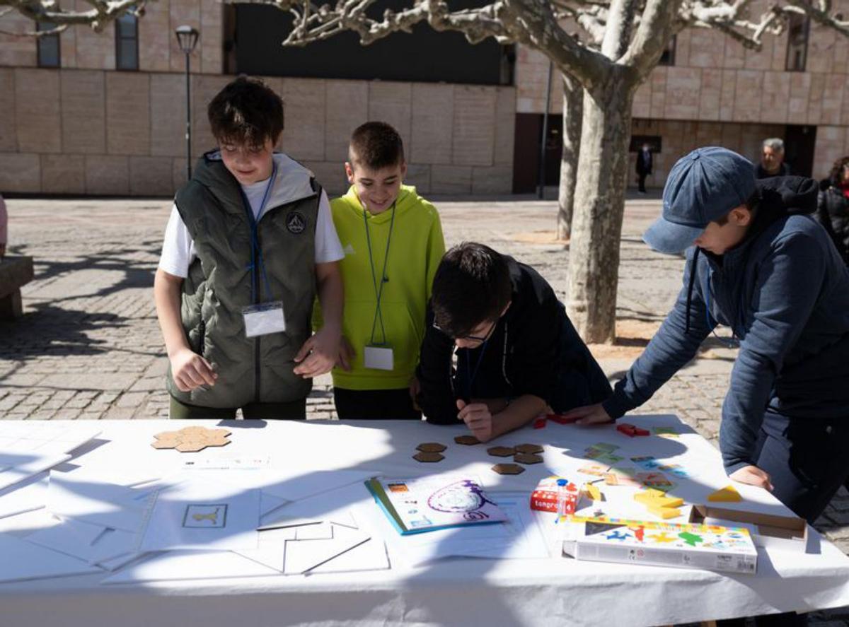 Varios jóvenes intentan solucionar uno de los retos. | E. Fraile