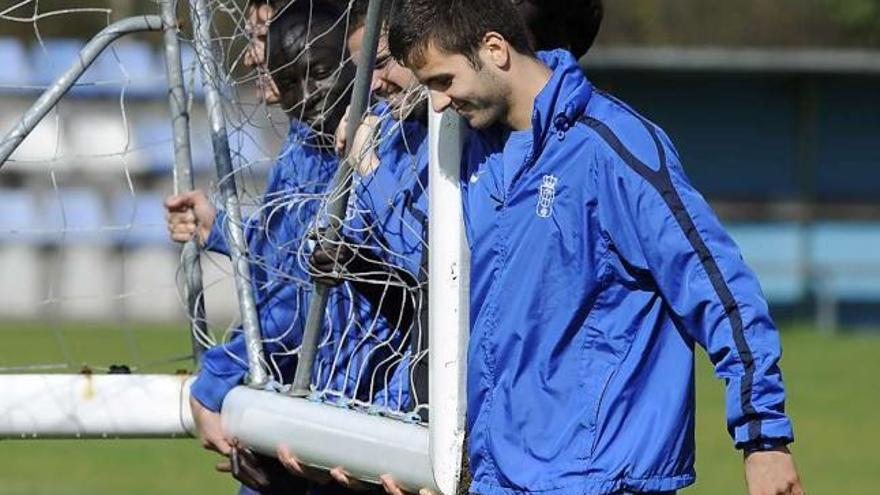 Pelayo retira una portería del entrenamiento junto a otros compañeros.