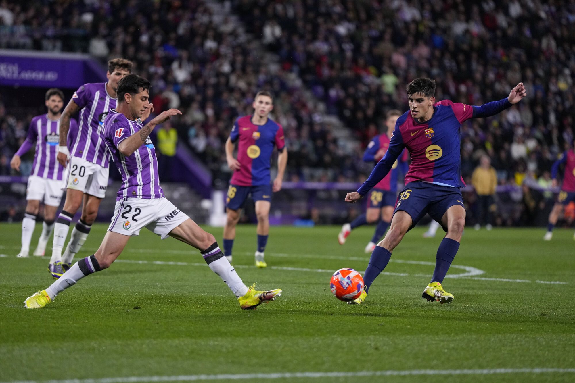 Barcelona's Gerard Martin, right, and Valladolid's Antonio Candela challenge for the ball during the Spanish La Liga soccer match between Valladolid and FC Barcelona at the Jose Zorrilla stadium in Valladolid, Spain, Saturday, May 3, 2025. (AP Photo/Manu Fernandez)