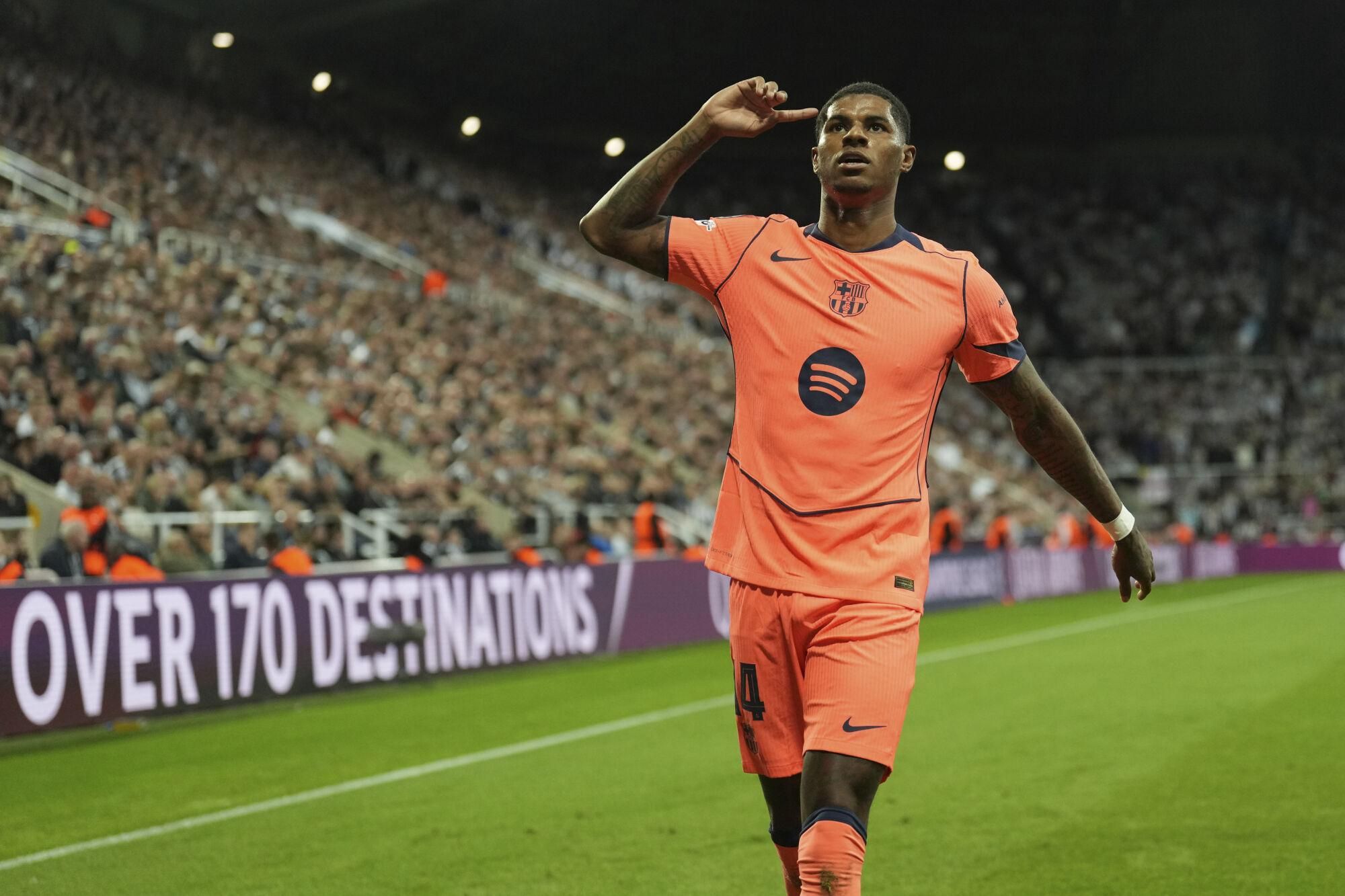 Barcelona's Marcus Rashford celebrates after scoring his side second goal during the Champions League, opening phase soccer match between Newcastle and Barcelona in Newcastle, England, Thursday, Sept. 18, 2025. (AP Photo/Jon Super)