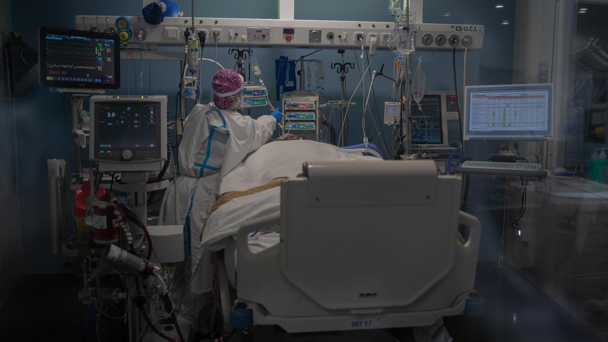 Una sanitaria atiende a un paciente en la UCI del Hospital del Mar, en Barcelona.