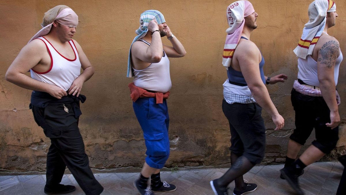 Costaleros tras relevar a sus compañeros en una parada por las calles centricas de Sevilla.