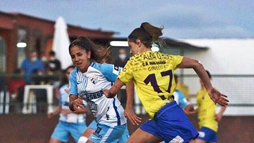 La amarilla Alba trata de llevarse el balón ante una jugadora del Málaga.