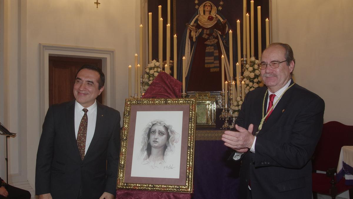 Antonio Montiel entrega al hermano mayor de Zamarrilla, Salvador Valderrama, el retrato donado a la hermandad.