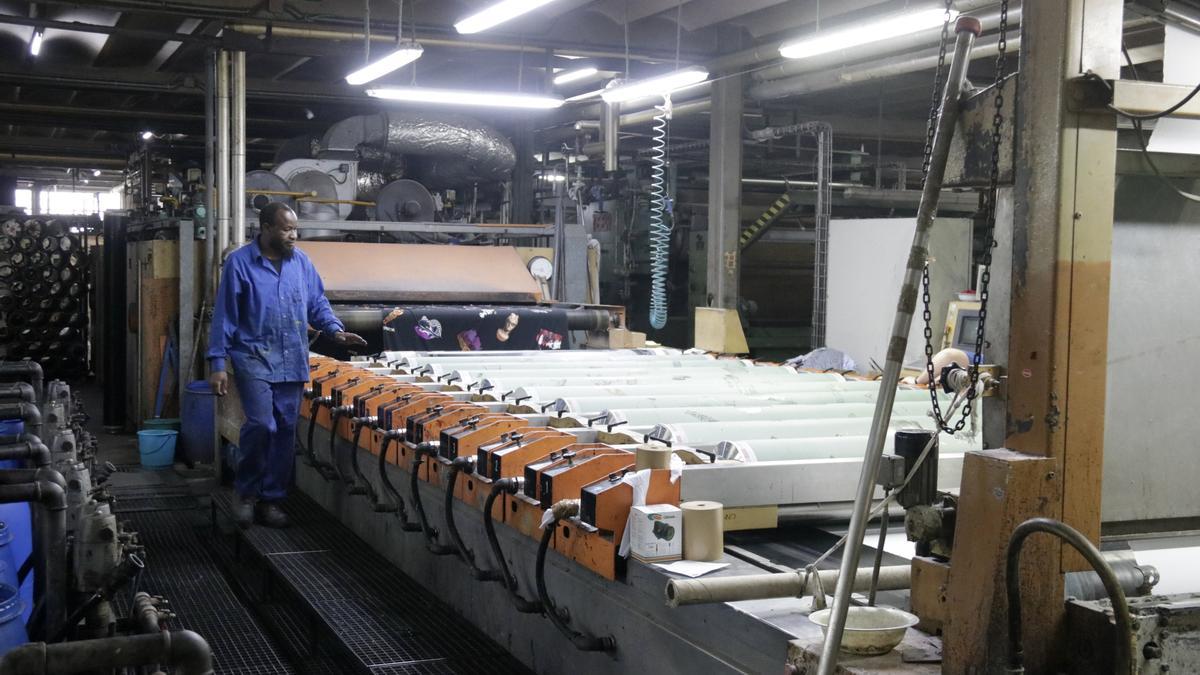 El treballador d&#039;una fàbrica tèxtil revisa el procés d&#039;estampació