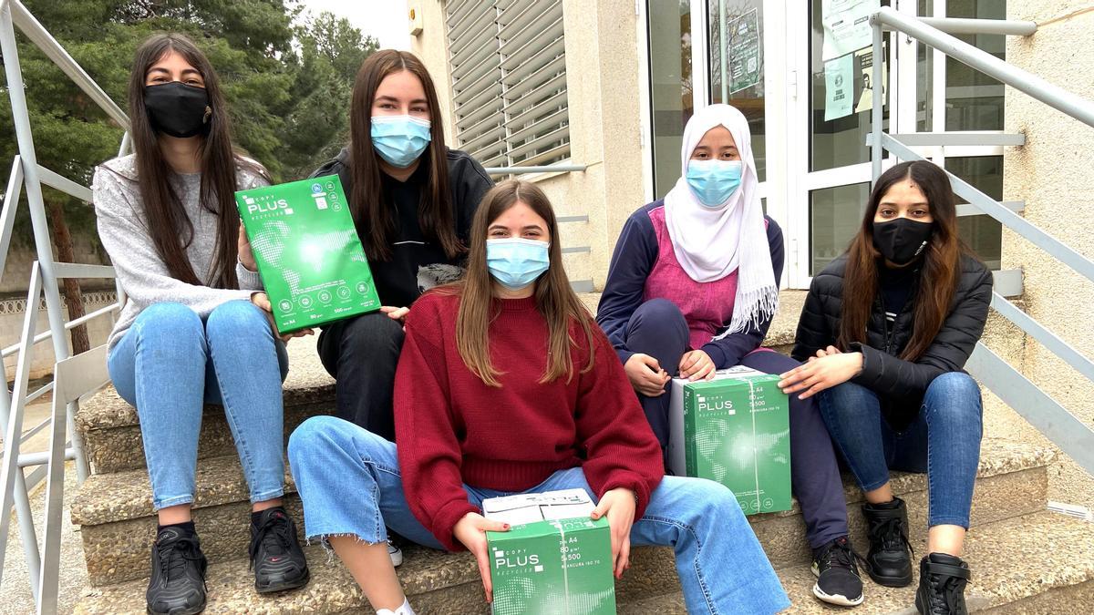 Alumnas de 1º de Bachillerato del IES Joaquín Costa de Cariñena con paquetes de papel reciclado.
