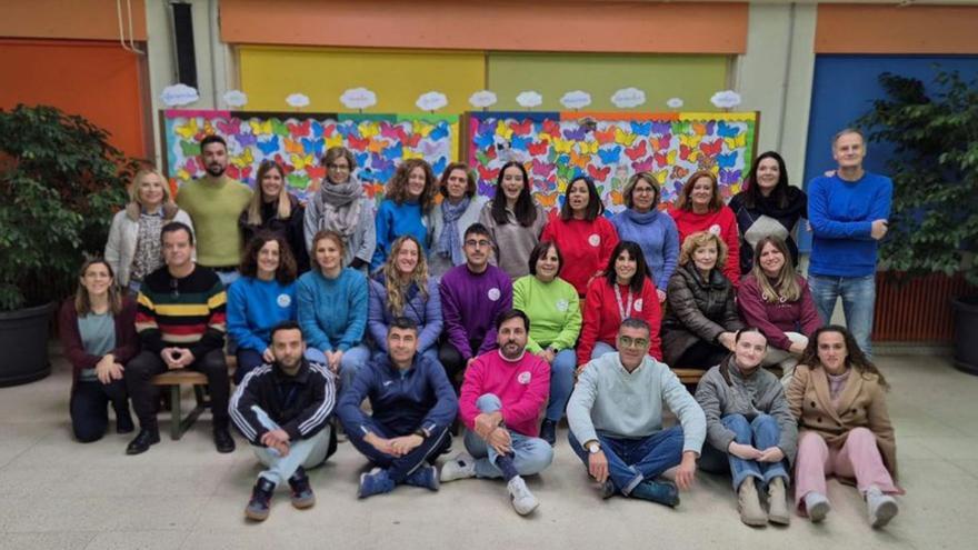 Los docentes con las obras de los alumnos al fondo.