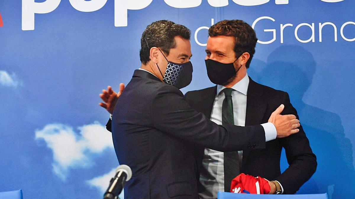 El líder del PP, Pablo Casado (d), abraza al presidente del PP-A y de la Junta, Juanma Moreno, ayer en Granada.