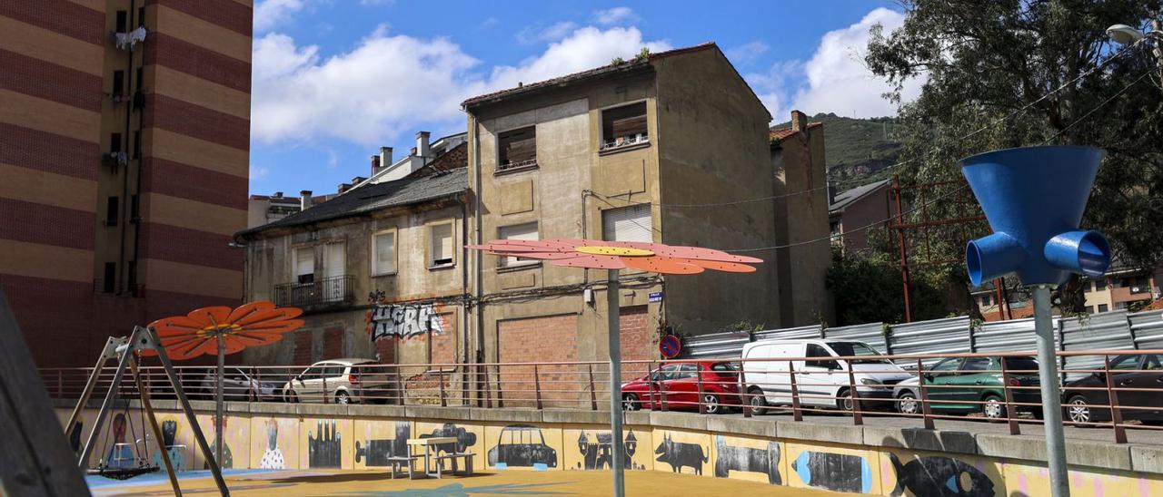 Los edificios abandonados situados tras el parque infantil de la plaza de Juan Pablo II que serán demolidos en septiembre. | Irma Collín