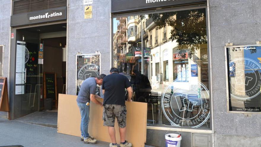 Operaris treballant per instal·lar, aquest dijous al matí, una fusta al lloc de la porta