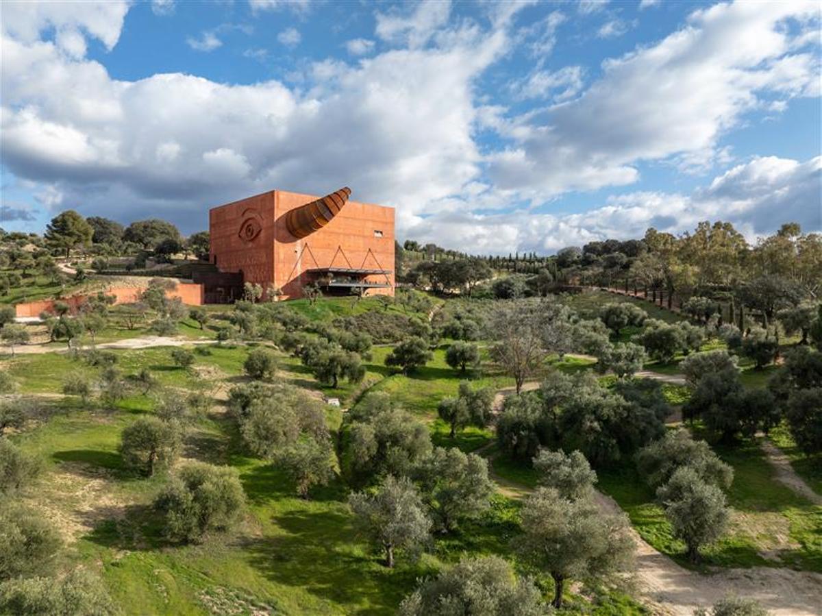 La almazara de Philippe Starck, un cubo rojo monolítico, con un inmenso cuerno de toro de acero