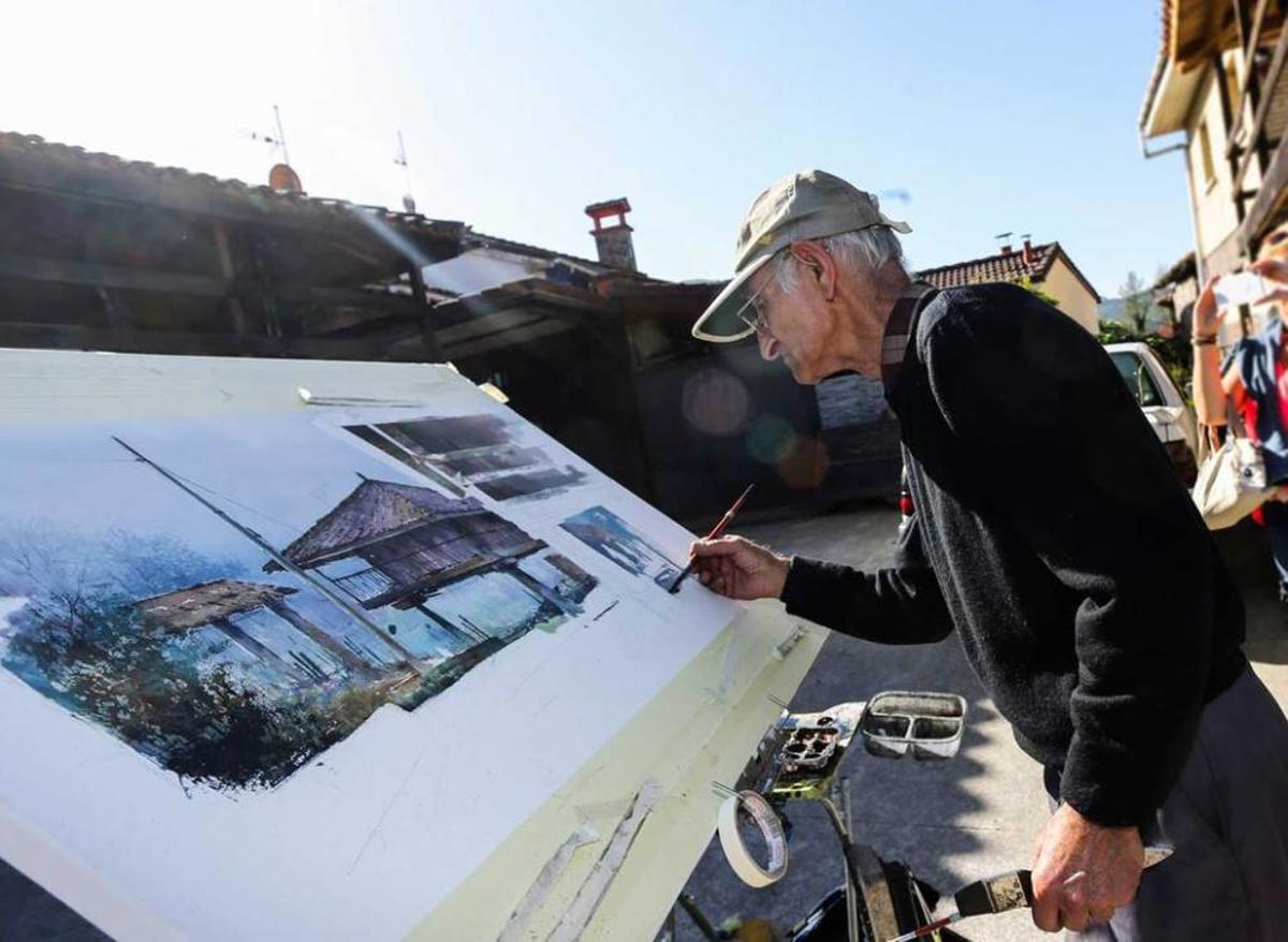 Pintor y caballete con hórreo al fondo