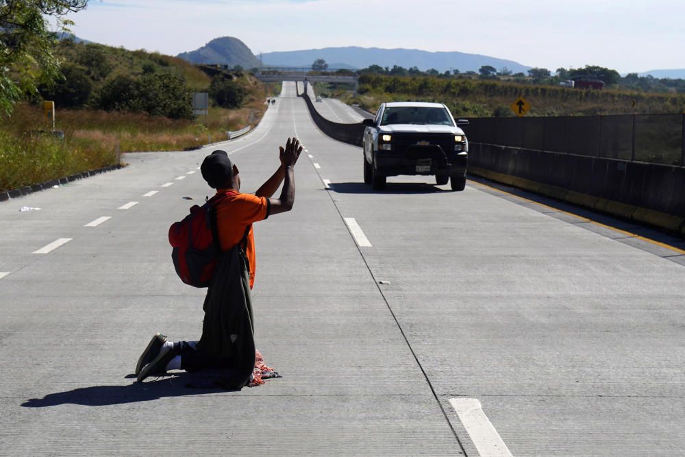 A migrant, part of a caravan of thousands ...