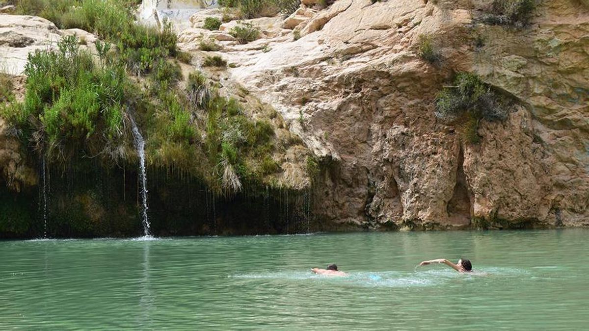 Dos personas se bañan en el oasis e Fuente Caputa